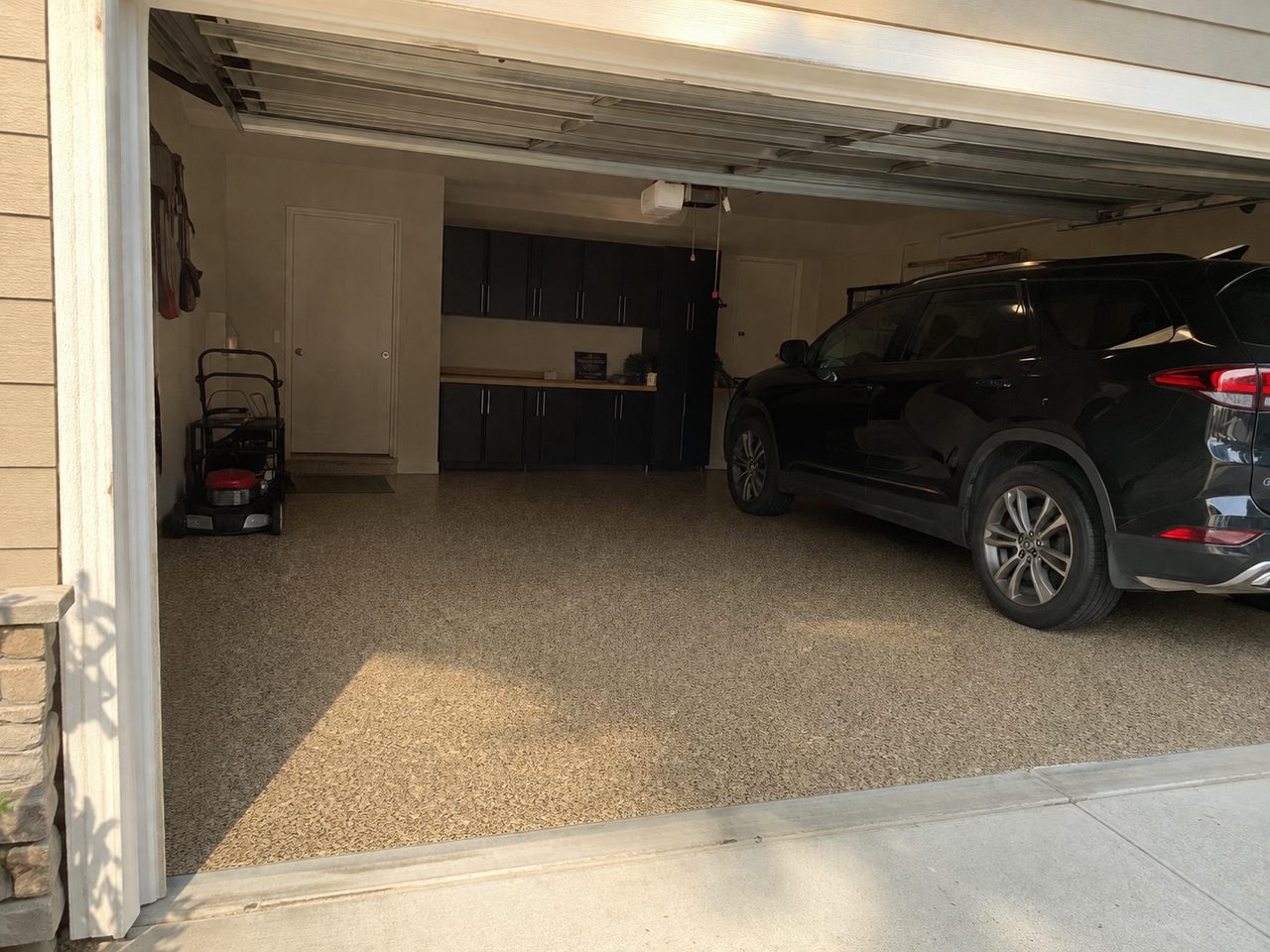Tan flake epoxy garage floor coating after installation in Daytona Beach